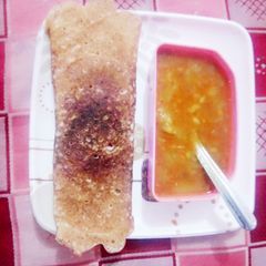 A picture of Dosa and sambar.