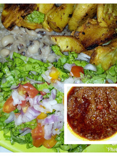 A picture of Mashed beans with crispy fried sweet potatoes and palm oil stew.