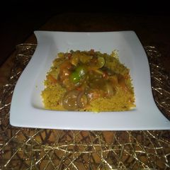 A picture of Couscous with curry beef soup.