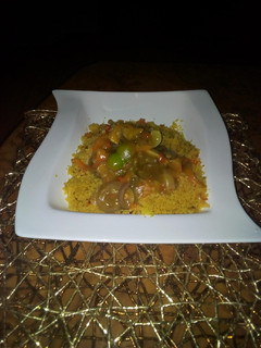 A picture of Couscous with curry beef soup.