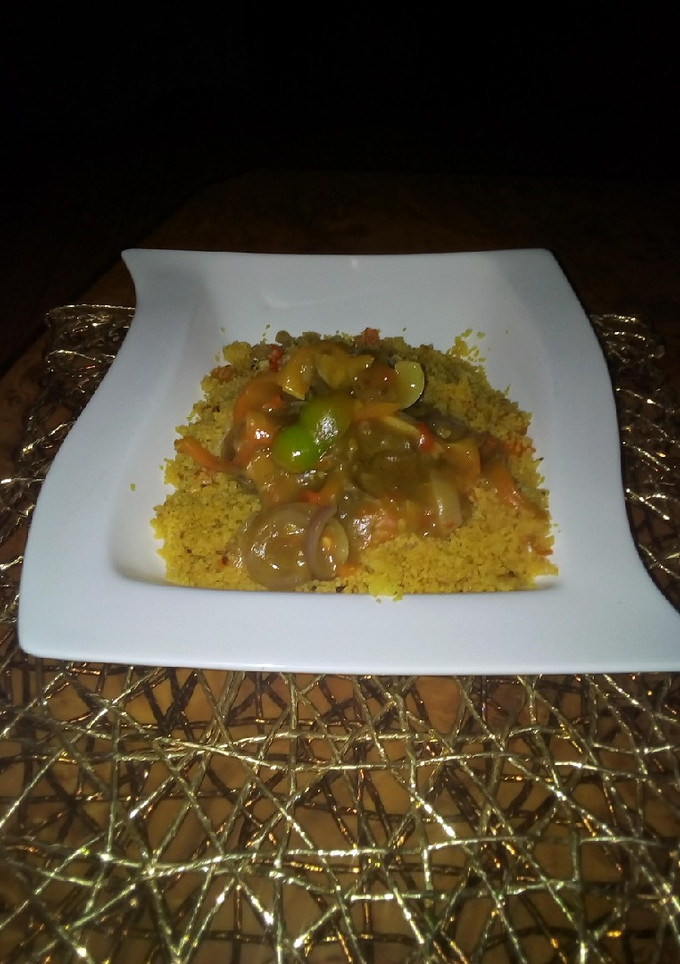 A picture of Couscous with curry beef soup.