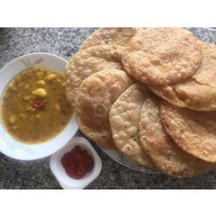 A picture of Kachori & Aloo achari tarkari.