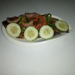 A picture of Garnished open fire grilled fish.