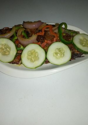A picture of Garnished open fire grilled fish.