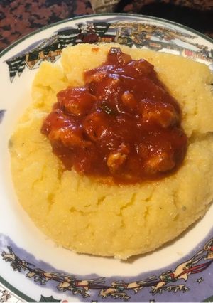 Una foto de Polenta con salsa roja de pollo