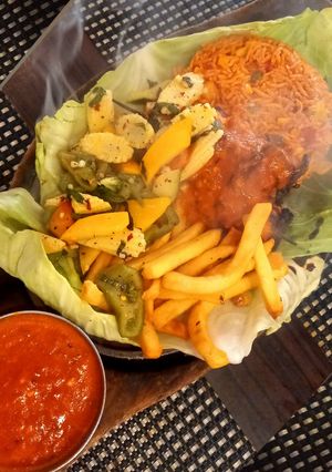 A picture of Paneer Shashkik Sizzler with Schezwan Corn Rice.