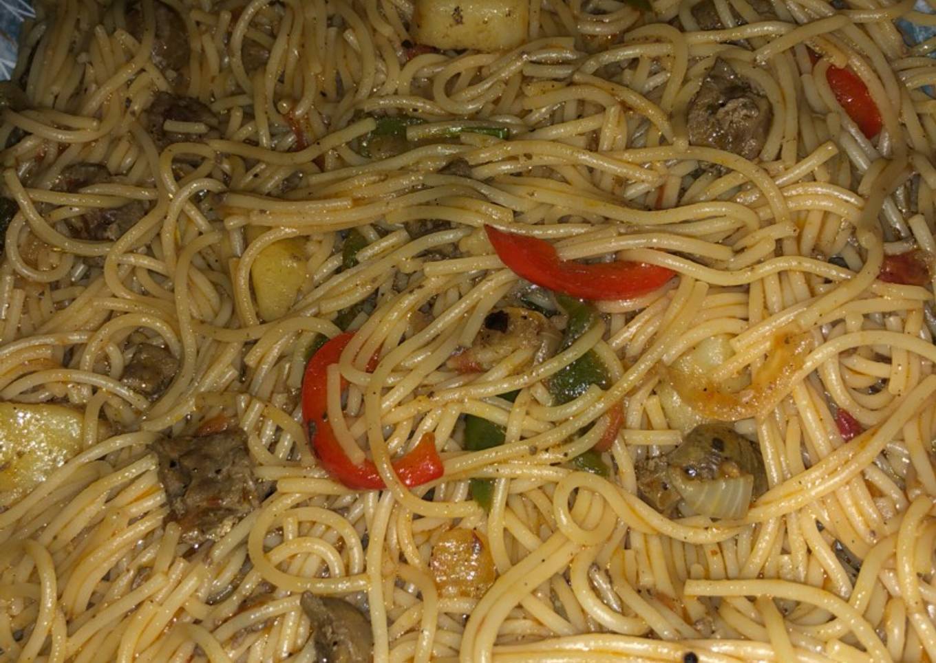 Spaghetti jollof with kidney and Irish potatoes