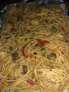 A picture of Spaghetti jollof with kidney and Irish potatoes.