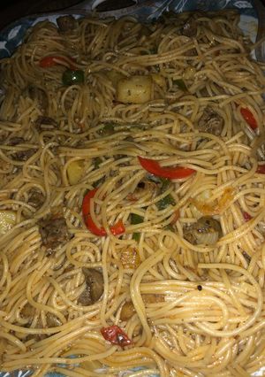 A picture of Spaghetti jollof with kidney and Irish potatoes.