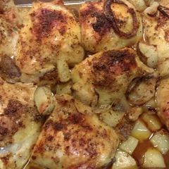 A picture of Baked thighs with potatoes.