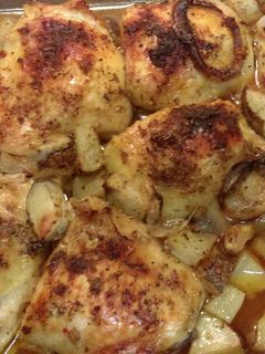 A picture of Baked thighs with potatoes.