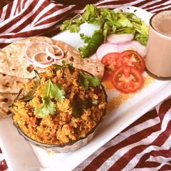 A picture of South Indian street style Egg bhurji made with chicken gravy.