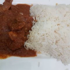 A picture of Chicken stew and rice.
