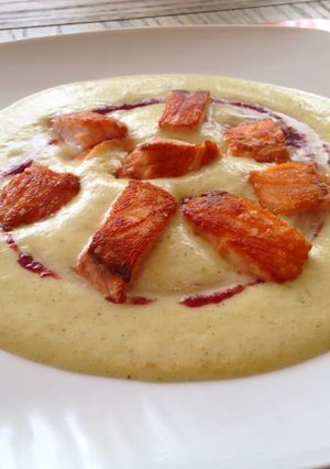 Una foto de Dados de salmón en mousse de calabacín y coulís de arándanos