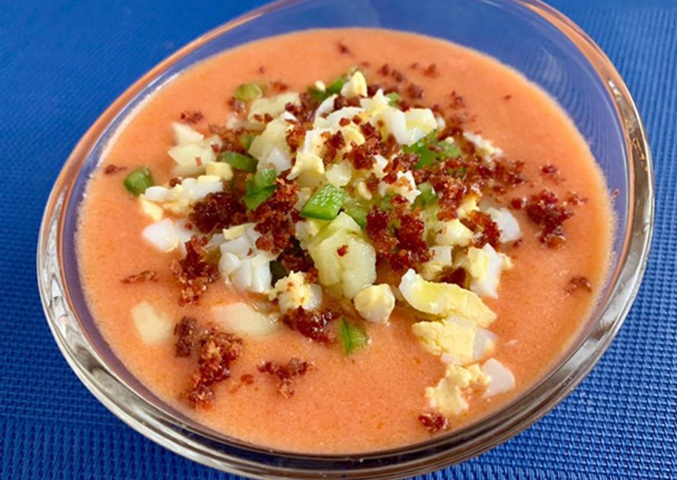 Crema de gazpacho asalmorejado con guarnición de verduras, jamón y huevo