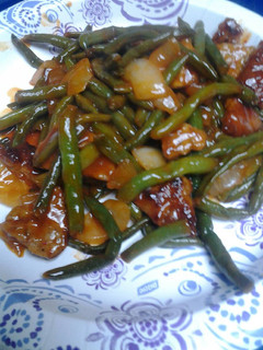 A picture of Green Beans and Sausage in a Sauce.
