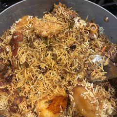 A picture of Thallakapatty Style Mutton Biriyani with Aloo Bengali fusion.
