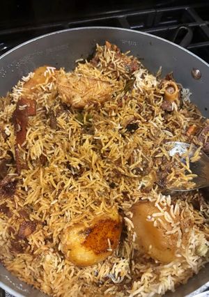 A picture of Thallakapatty Style Mutton Biriyani with Aloo Bengali fusion.