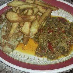 Fried sweet potatoes wit fried egg n chicken sauce A picture of Fried sweet potatoes wit fried egg n chicken sauce.
