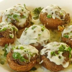 Hummus stuffed cheesy mushrooms A picture of Hummus stuffed cheesy mushrooms.
