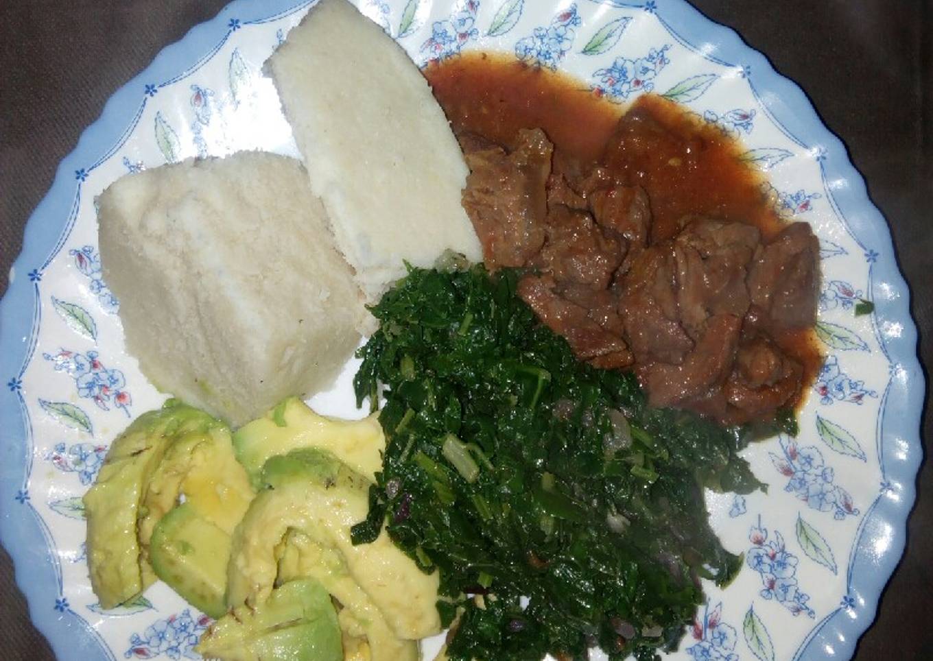 Ugali with wet fry beef n mixed greens/guacamole