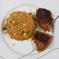 A picture of Jollof rice and chicken.