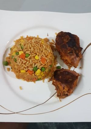 A picture of Jollof rice and chicken.