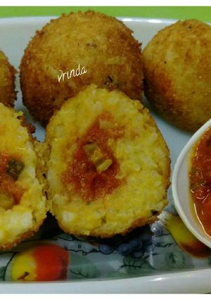 A picture of Fried Sambhar Rice Balls with stuffed Concasse Sauce.