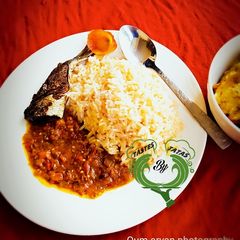 A picture of White Rice and Stew with fried fish.