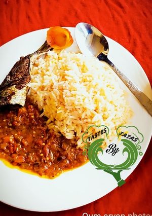 A picture of White Rice and Stew with fried fish.