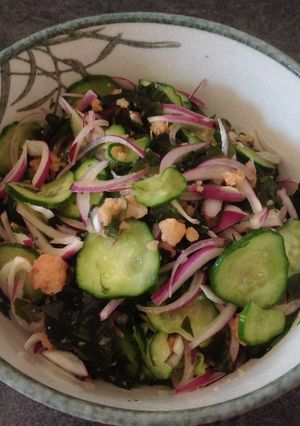 A picture of Salad with smoked salmon, wakame,cucumber and red onion.