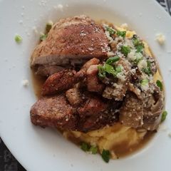 A picture of Polenta with mushroom sauce and turkey.