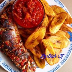 A picture of Fried plantain with grilled fish and sauce.