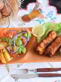 Rolled pork chops filled with "cheesy surprise" avocado salad a fried potato chips