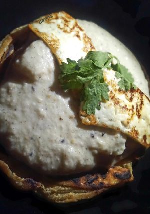 A picture of Sufiyana paneer(on the bed of lachcha parantha).