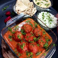 A picture of Dryfruit Stuffed Tomatoes In Rich Gravy.