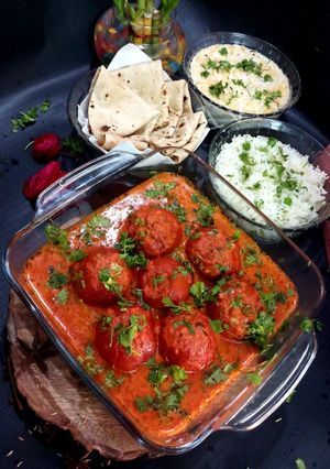 A picture of Dryfruit Stuffed Tomatoes In Rich Gravy.