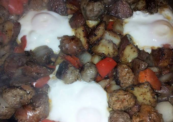Skillet fried sausage, mushrooms, peppers and onion with egg