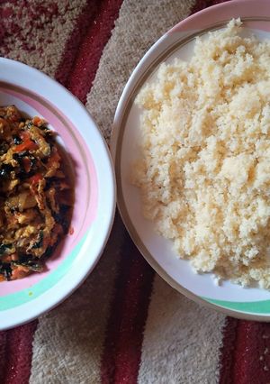 A picture of White couscous with egg sauce.