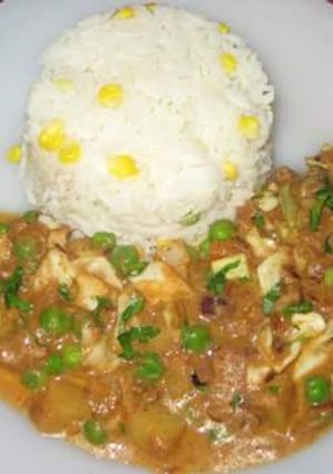A picture of Creamy vegetable curry served with sweet corn rice.