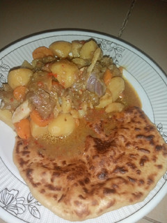 A picture of Butter Naan Bread with Potato Soup.