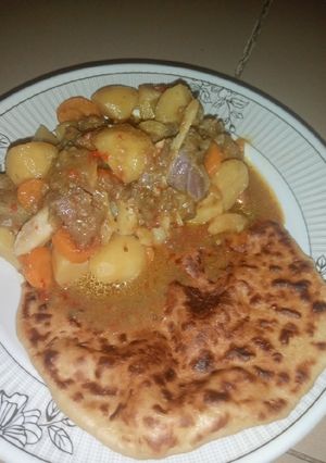 A picture of Butter Naan Bread with Potato Soup.