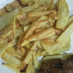 A picture of French fries with chicken.