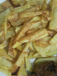 A picture of French fries with chicken.
