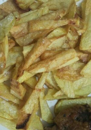 A picture of French fries with chicken.