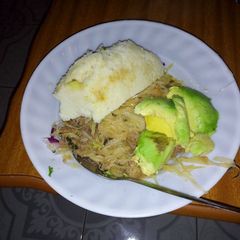 A picture of Ugali, stewed cabbage and avocado.