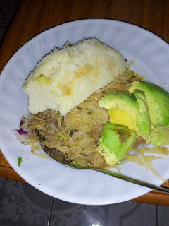A picture of Ugali, stewed cabbage and avocado.