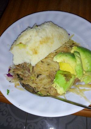 A picture of Ugali, stewed cabbage and avocado.