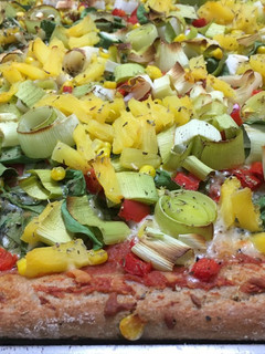 A picture of Pizza with Pineapple and Spinach.
