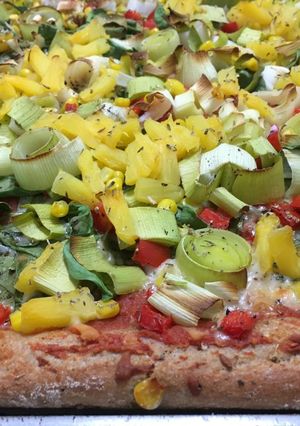 A picture of Pizza with Pineapple and Spinach.